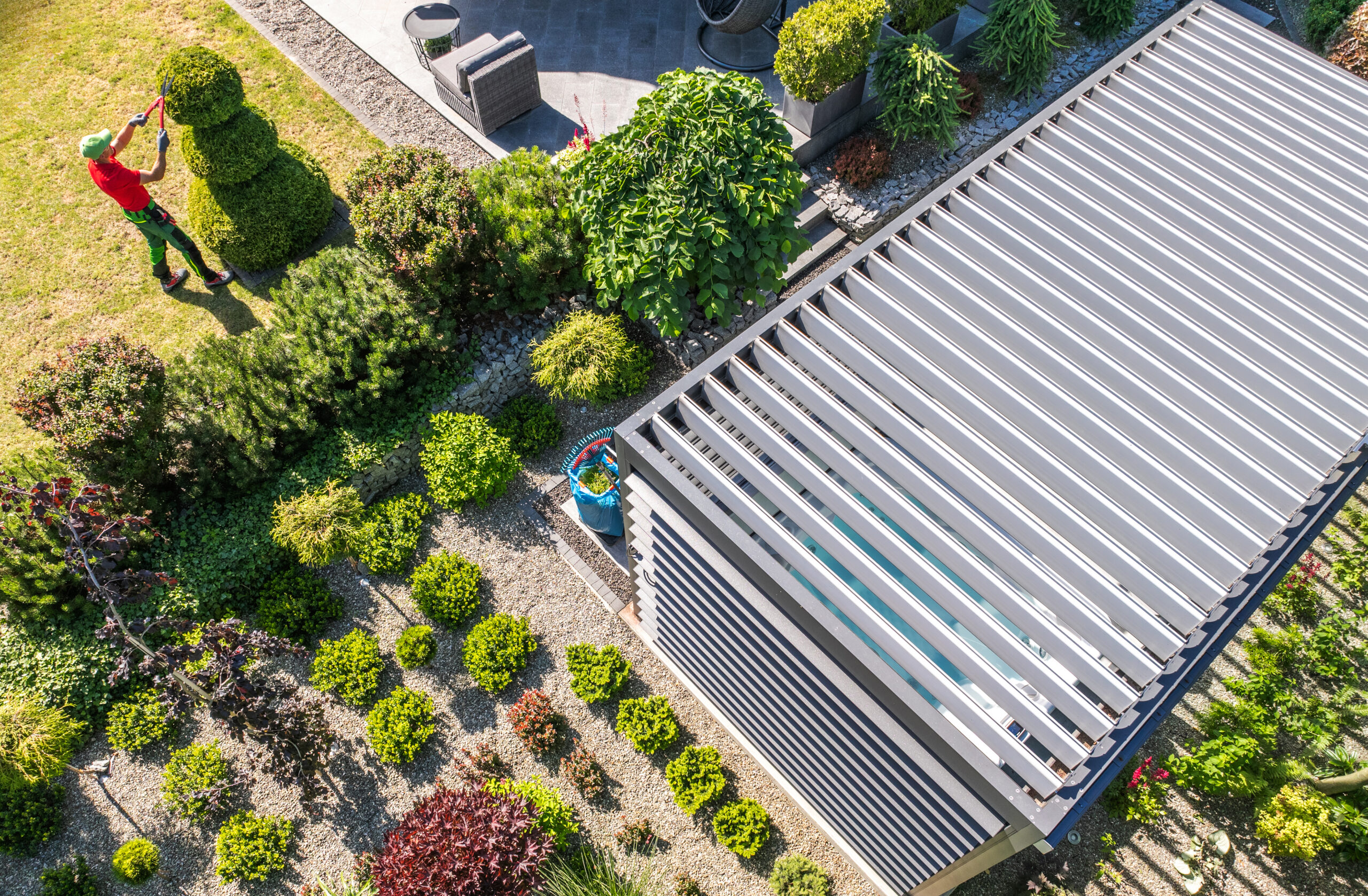 Motorised aluminium louvre roof pergola installed over a garden patio, creating a modern outdoor living and dining space - Shade Space